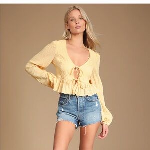 Lulus “Dreamy Delight Light Yellow Long Sleeve Tie-Front Peplum Top”